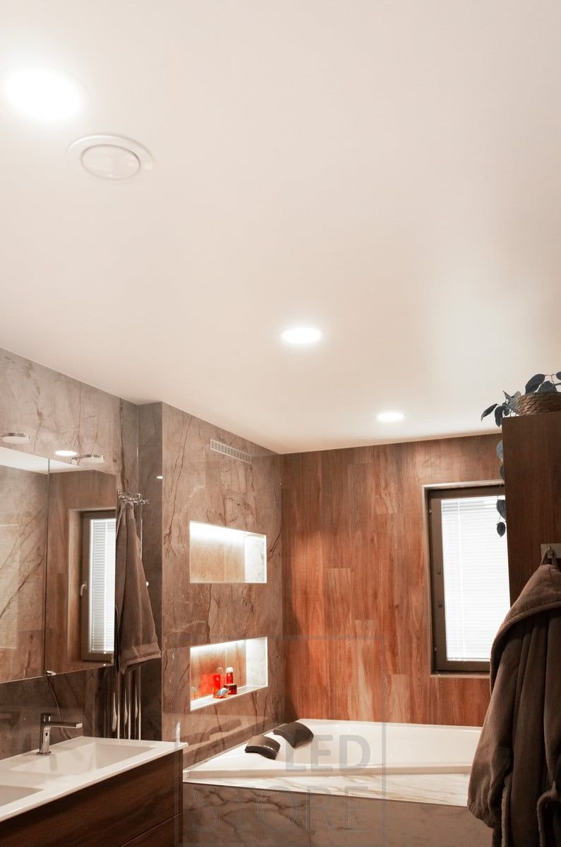 LED ceiling tiles in the bathroom. The light emitted by the luminaire is more uniform than a spotlight and is ideal for general lighting.